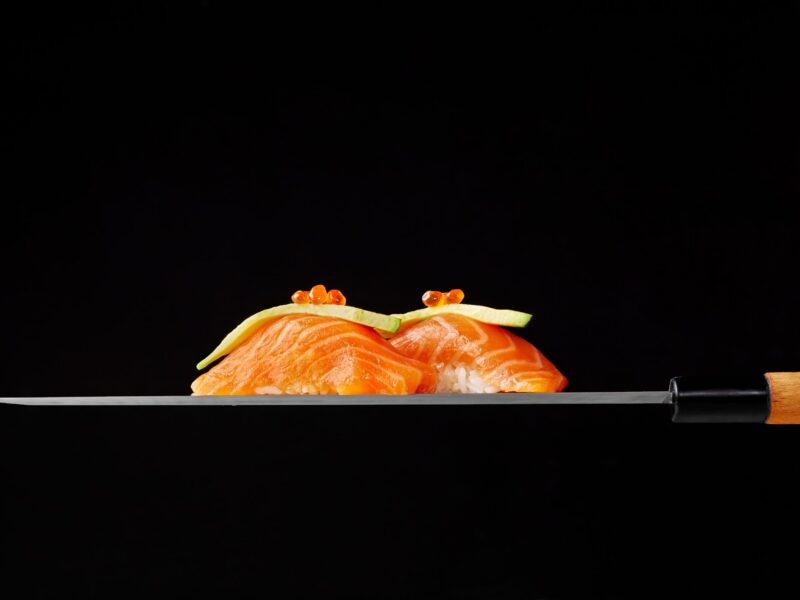 nigiri-sushi-with-raw-salmon-avocado-red-caviar-blade-japanese-knife-1-scaled