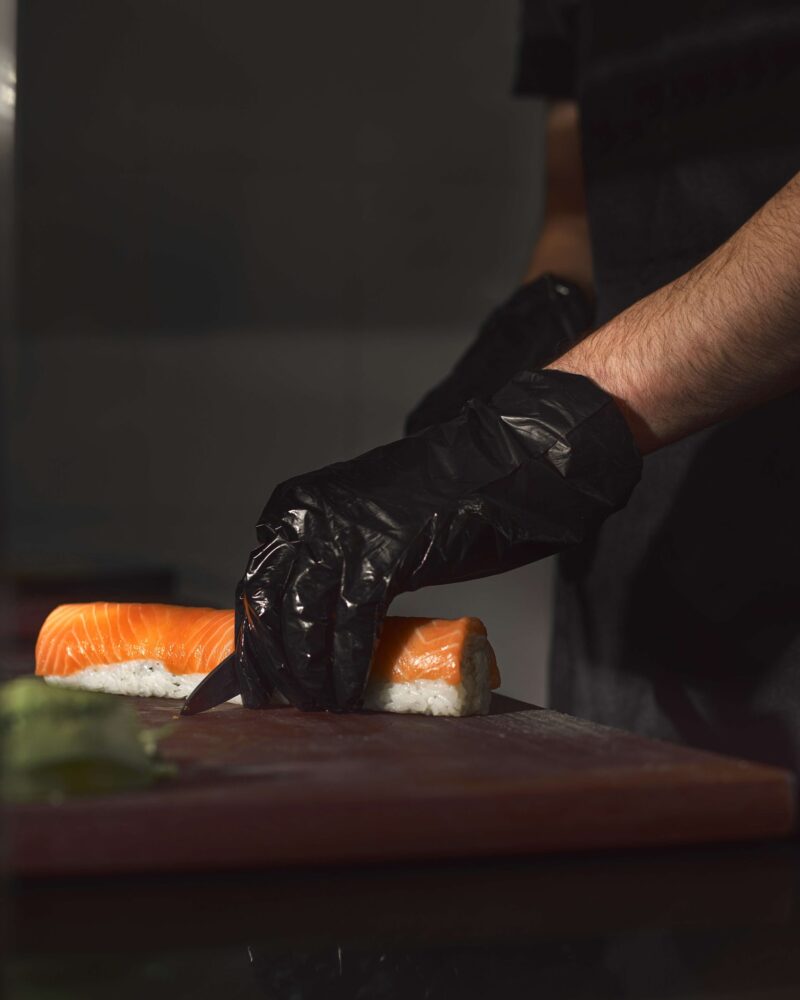 sushi-chef-slices-fresh-salmon-sushi-bar-chef-cutting-sushi-professional-kitchen-creative-work-scaled sushi-chef-slices-fresh-salmon-sushi-bar-chef-cutting-sushi-professional-kitchen-creative-work-scaled